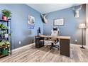 Office with wood laminate flooring, blue painted walls, and a mounted deer head at 4781 Rosette St, Castle Rock, CO 80104