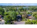 Scenic aerial view of home, showcasing solar panels, lush landscaping, and proximity to the nearby lake at 1424 Cypress Cir, Lafayette, CO 80026