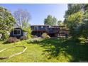 Charming backyard with mature trees, deck, and shed, perfect for outdoor living and entertaining at 1424 Cypress Cir, Lafayette, CO 80026