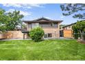 Spacious backyard with lush green grass and a private balcony area at 2067 Depew St, Edgewater, CO 80214