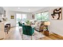 Bright living room featuring modern decor, large windows, and hardwood floors at 2067 Depew St, Edgewater, CO 80214