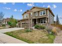 Well-maintained home featuring a three-car garage and a beautifully landscaped front yard at 13440 Monaco St, Thornton, CO 80602