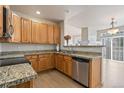 This kitchen features stainless appliances, granite countertops, and hardwood floors at 7353 Norfolk Pl, Castle Pines, CO 80108
