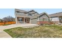 Beautiful home featuring mature landscaping, brick accents, and an attached two-car garage at 3097 Madison Ln, Broomfield, CO 80023
