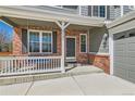 Inviting front porch of a home with a porch swing, brick facade, and address numbers at 3097 Madison Ln, Broomfield, CO 80023