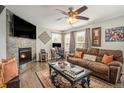 Inviting living room with a stone fireplace, comfortable seating, and lots of natural light at 16328 E Phillips Ln, Englewood, CO 80112