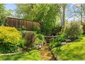 Picturesque backyard showcasing a stream and lush greenery creating a serene natural setting at 4425 Irving St, Denver, CO 80211
