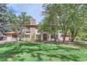 Stunning two-story home with manicured lawn and mature trees at 5635 E 17Th Avenue Pkwy, Denver, CO 80220