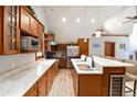 Modern kitchen featuring stainless appliances, granite counters, an island with a wine cooler, and wood floors at 302 N Main St, Breckenridge, CO 80424