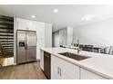 Beautiful kitchen with stainless steel appliances, a large island, and an adjacent dining area at 1927 S Peoria St, Aurora, CO 80014