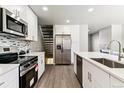 Modern kitchen features stainless steel appliances, quartz countertops, and stylish backsplash at 1927 S Peoria St, Aurora, CO 80014