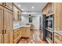 Bright kitchen featuring wood cabinets, stainless steel appliances, and stone countertops at 13624 Omega Cir, Lone Tree, CO 80124