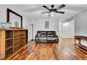 Cozy living room with hardwood floors and a dark leather sofa at 13624 Omega Cir, Lone Tree, CO 80124
