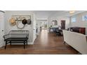 Welcoming entryway showcasing hardwood floors, neutral walls, and a glimpse into the dining area at 23101 Timber Spring Ln, Parker, CO 80138