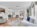 Bright and airy living room with hardwood floors and modern decor at 9946 Harrison St, Thornton, CO 80229