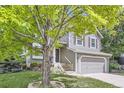 Charming two-story home with a manicured lawn, mature trees, and a welcoming front door at 12256 Utica St, Broomfield, CO 80020