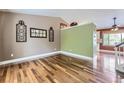 Bright living room featuring hardwood floors, stylish decor, and lots of natural light from a large window at 12256 Utica St, Broomfield, CO 80020
