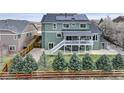 A spacious backyard featuring a large deck, mature trees, and privacy fencing at 1348 Lawson Ave, Erie, CO 80516