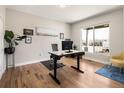 Bright office space with hardwood floors, a modern desk, and large window providing ample natural light at 3427 S Cherry St, Denver, CO 80222