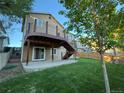 Inviting backyard deck with railings, stairs down to the yard, and a convenient sliding door at 23760 Broadmoor Dr, Parker, CO 80138