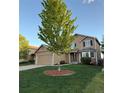 Charming two-story home with a well-maintained lawn and attached two-car garage at 23760 Broadmoor Dr, Parker, CO 80138