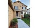 Inviting home entrance with meticulously kept landscaping and a freshly sealed walkway at 23760 Broadmoor Dr, Parker, CO 80138