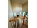 View of the open living area from the stairs with a cozy fireplace and large windows at 23760 Broadmoor Dr, Parker, CO 80138