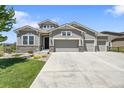 Charming home featuring stone accents and a well-manicured lawn at 8661 S De Gaulle Ct, Aurora, CO 80016