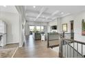 Spacious living room boasts a coffered ceiling and large windows to the outside at 8661 S De Gaulle Ct, Aurora, CO 80016