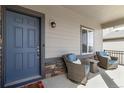Inviting front porch with seating area, stylish door, and well-maintained facade at 12759 Buffington Trl, Parker, CO 80134