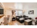 Inviting living room with hardwood floors, modern decor, and lots of natural light coming in at 6033 Hoyt Ct, Arvada, CO 80004