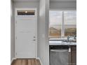 Bright kitchen features stainless steel appliances, granite countertop, and natural light from the window at 847 Great Plains Ave, Berthoud, CO 80513