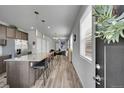 Open-concept kitchen featuring a large island, pendant lighting, and stainless steel appliances, perfect for modern living at 847 Great Plains Ave, Berthoud, CO 80513
