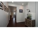 Inviting entryway featuring dark wood floors and a cabinet with glass doors at 635 Silver Rock Trl, Castle Rock, CO 80104