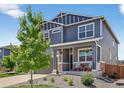 Well-maintained two-story home showcasing a landscaped front yard and inviting covered porch with decor at 635 Silver Rock Trl, Castle Rock, CO 80104