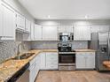 Updated kitchen featuring granite countertops and stainless steel appliances at 12565 Sheridan Blvd # 208, Broomfield, CO 80020