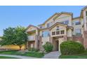 Attractive condo building featuring private balconies and well-maintained landscaping at 5726 N Genoa Way # 301, Aurora, CO 80019