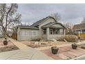 Charming single-story home featuring a cozy front porch, a mix of stone and mulch landscaping and a classic design at 109 W Simpson St, Lafayette, CO 80026
