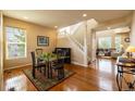 Elegant dining room with hardwood floors and staircase to the second floor at 7661 Chickaree Ct, Littleton, CO 80125