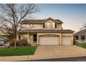 Inviting two-story home featuring a covered porch and a spacious three-car garage at 7661 Chickaree Ct, Littleton, CO 80125