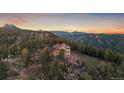 Majestic home nestled among pine trees with mountain views providing privacy and tranquility at 23007 Big Game Trl, Conifer, CO 80433