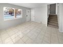 Living room with tile floors and staircase at 481 S Lima Cir, Aurora, CO 80012