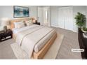 Virtually staged main bedroom with light wood platform bed and large closet at 481 S Lima Cir, Aurora, CO 80012