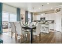 Dining area with hardwood floors, stylish furnishings, and sliding glass doors leading to the backyard at 3218 Belleville Ridge Rd, Elizabeth, CO 80107