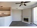 Cozy living area showcases fireplace and opens to kitchen with breakfast bar at 1652 Egret Way, Superior, CO 80027