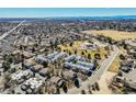 Aerial view of home near park featuring mature trees, a fountain, a track, and mountain views at 15157 E Louisiana Dr # A, Aurora, CO 80012