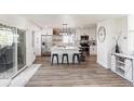 Bright, modern kitchen featuring white cabinets, stainless steel appliances, and an island with bar seating at 17067 Motsenbocker Way, Parker, CO 80134