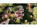 Stunning aerial view of an estate with a terracotta roof, lush landscaping, and ample parking at 3 Carriage Brook Rd, Cherry Hills Village, CO 80121
