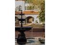 Exterior featuring a tiered fountain, red roof, and arched entrance at 3 Carriage Brook Rd, Cherry Hills Village, CO 80121