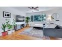 Sun-filled living room with hardwood floors and a comfortable seating area at 3049 S Williams St, Denver, CO 80210